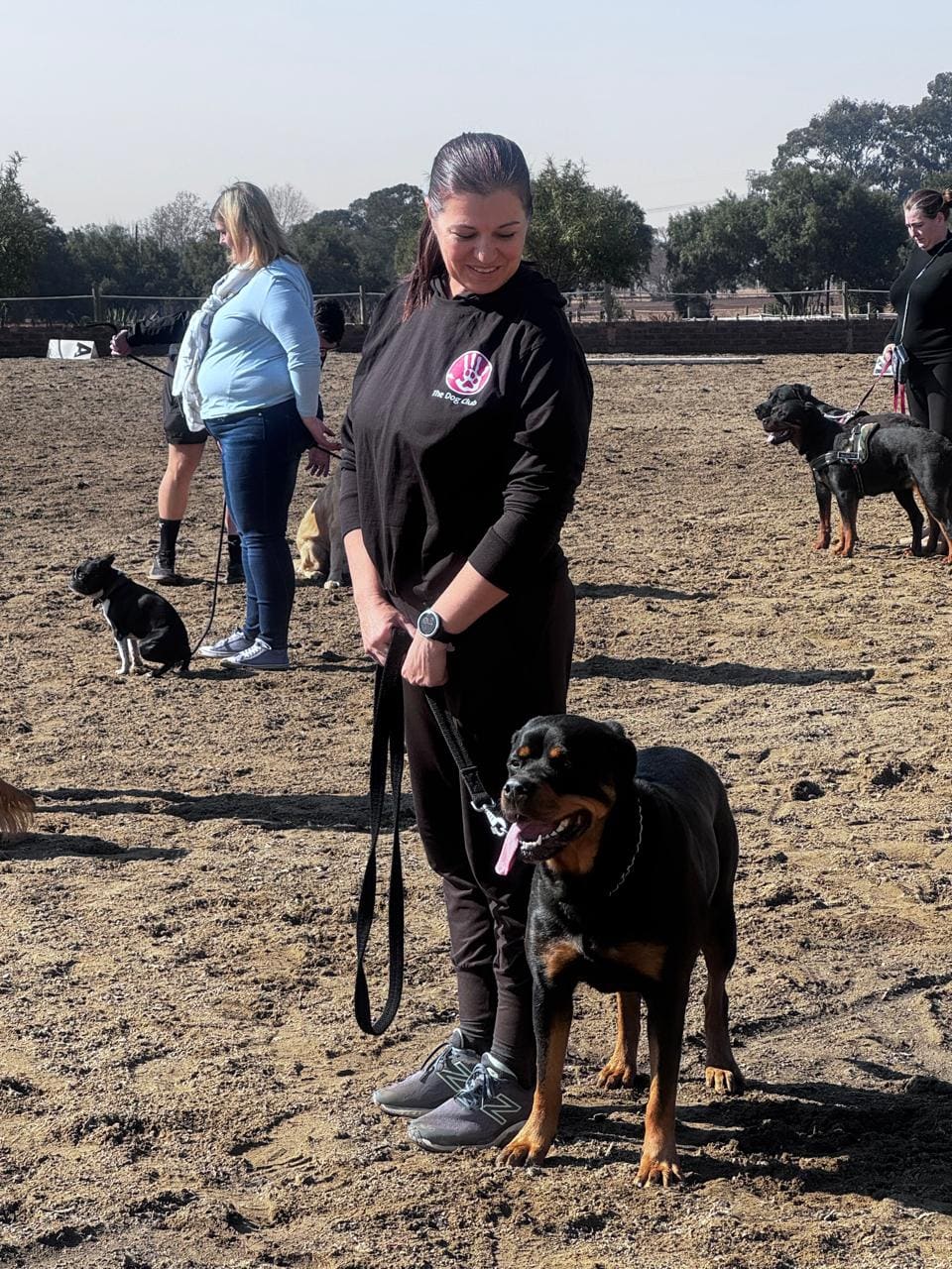 A Dog Club handler working a Dobermann on lead during a lesson